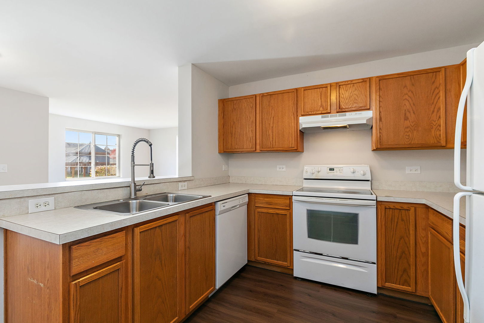 1809 Silverstone Drive, Unit 1809 Carpentersville, IL 60110 - Photo 8 of 17 a kitchen with stainless steel appliances granite countertop a sink stove and refrigerator