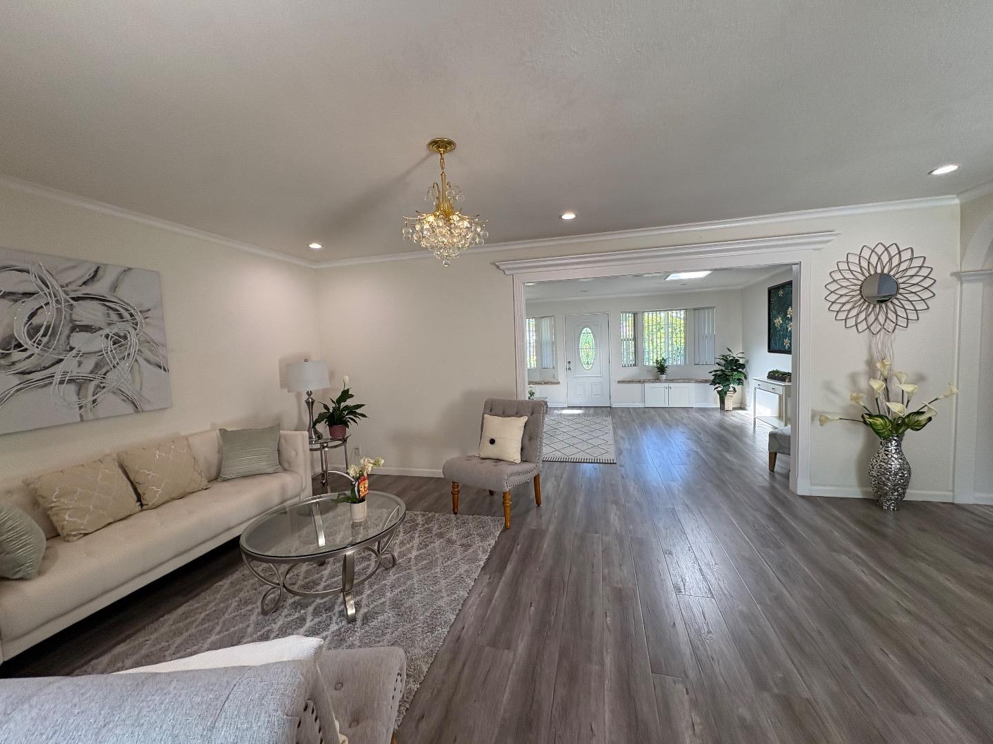 5187 Doyle Road San Jose, CA 95129 - Photo 5 of 39 a living room with couches and painting on the wall with wooden floor