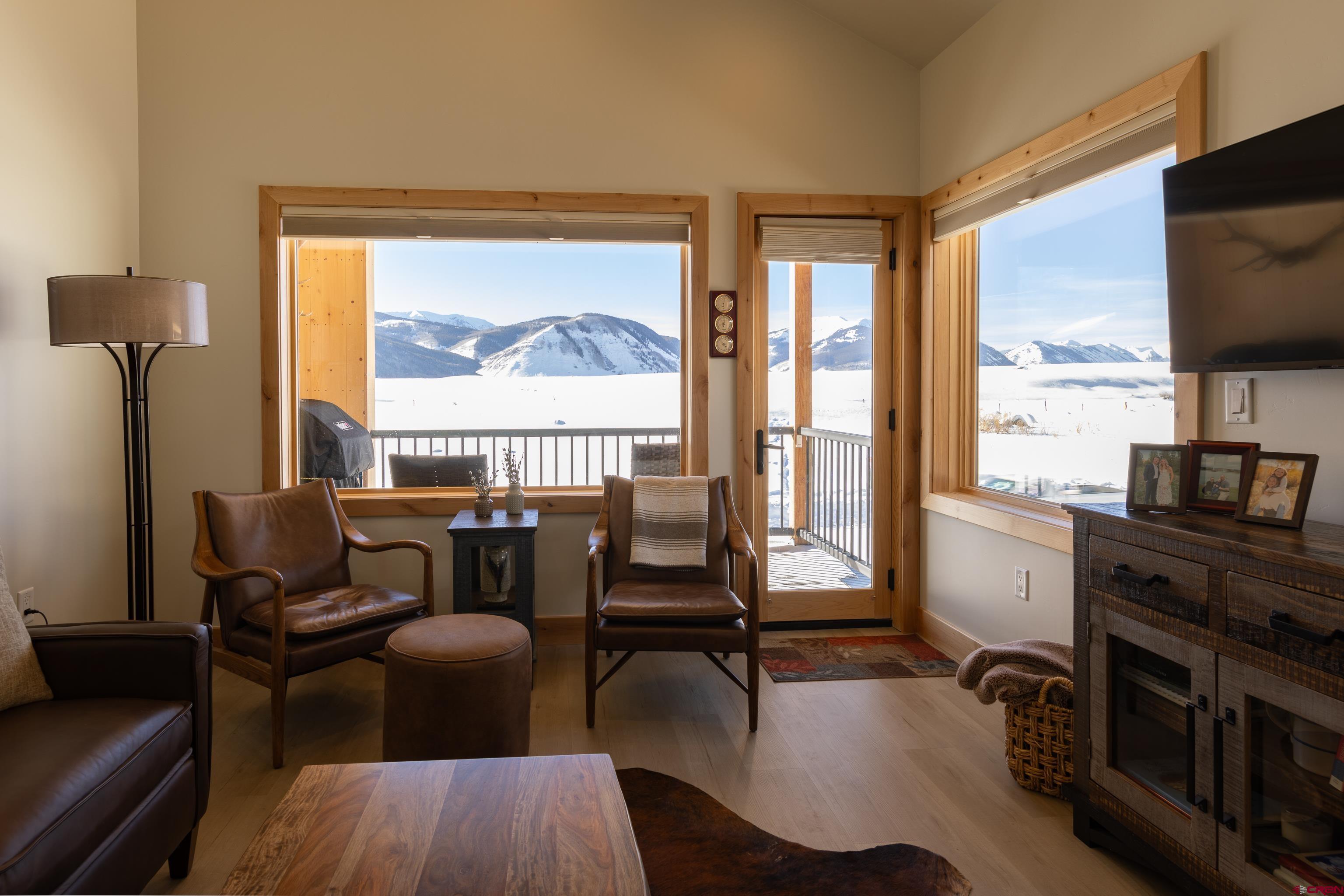 101 Elk Valley Road, Unit B Crested Butte, CO 81224 - Photo 11 of 33 a living room with furniture a flat screen tv and a floor to ceiling window