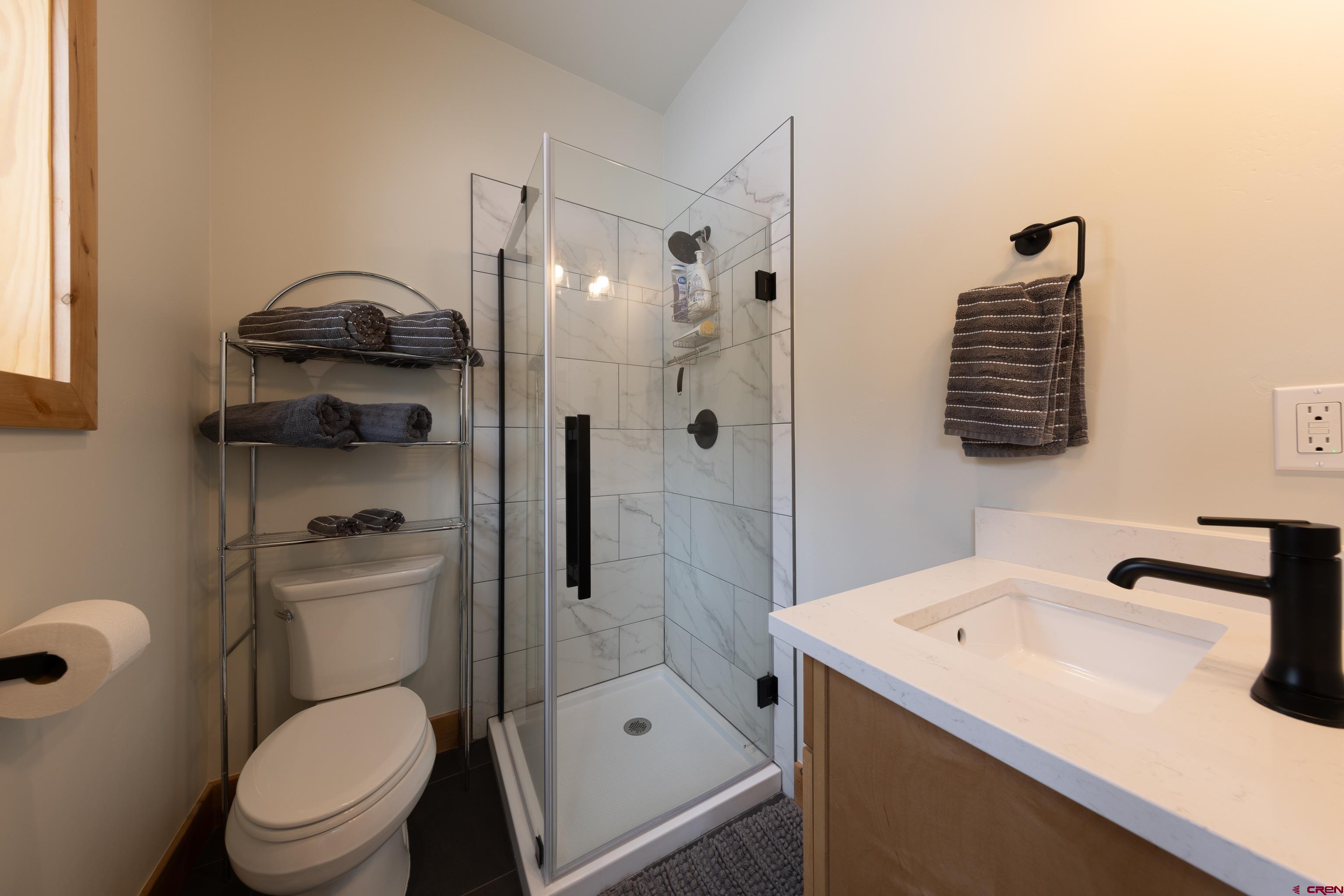 101 Elk Valley Road, Unit B Crested Butte, CO 81224 - Photo 26 of 33 a bathroom with a sink a toilet and shower