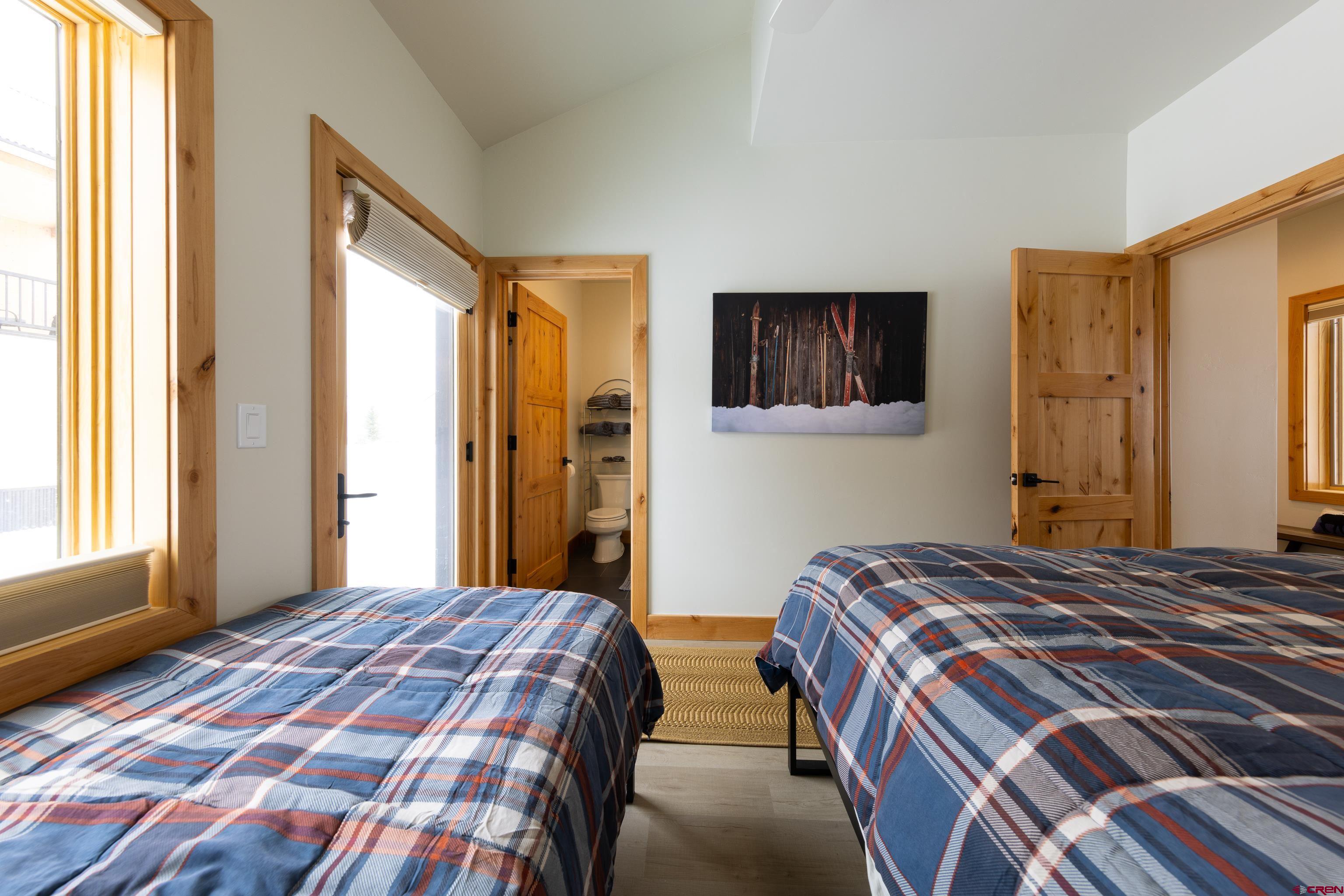 101 Elk Valley Road, Unit B Crested Butte, CO 81224 - Photo 28 of 33 a bedroom with a bed and a window