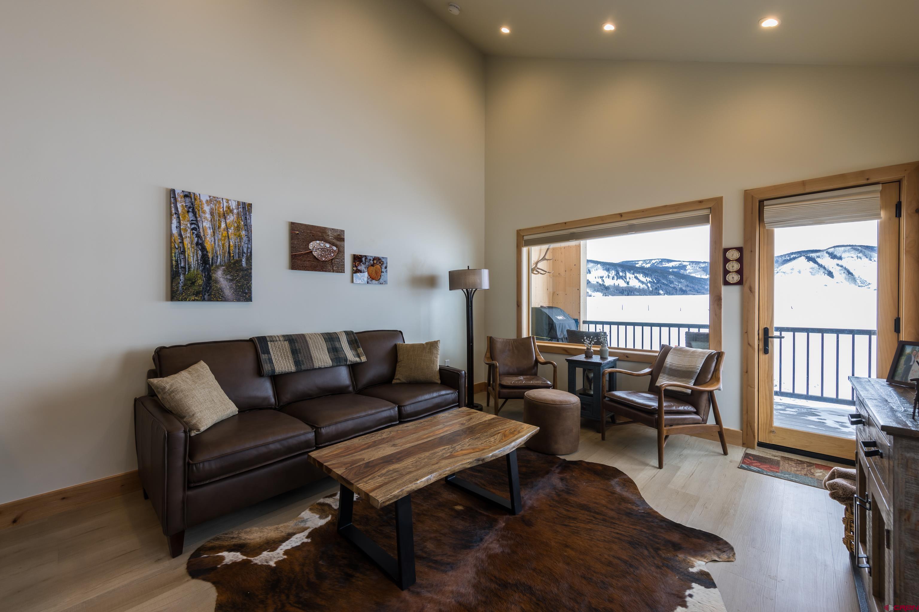 101 Elk Valley Road, Unit B Crested Butte, CO 81224 - Photo 9 of 33 a living room with furniture and a flat screen tv with wooden floor