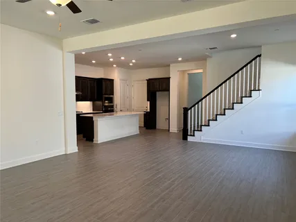 a kitchen with stainless steel appliances granite countertop a refrigerator and a stove top oven