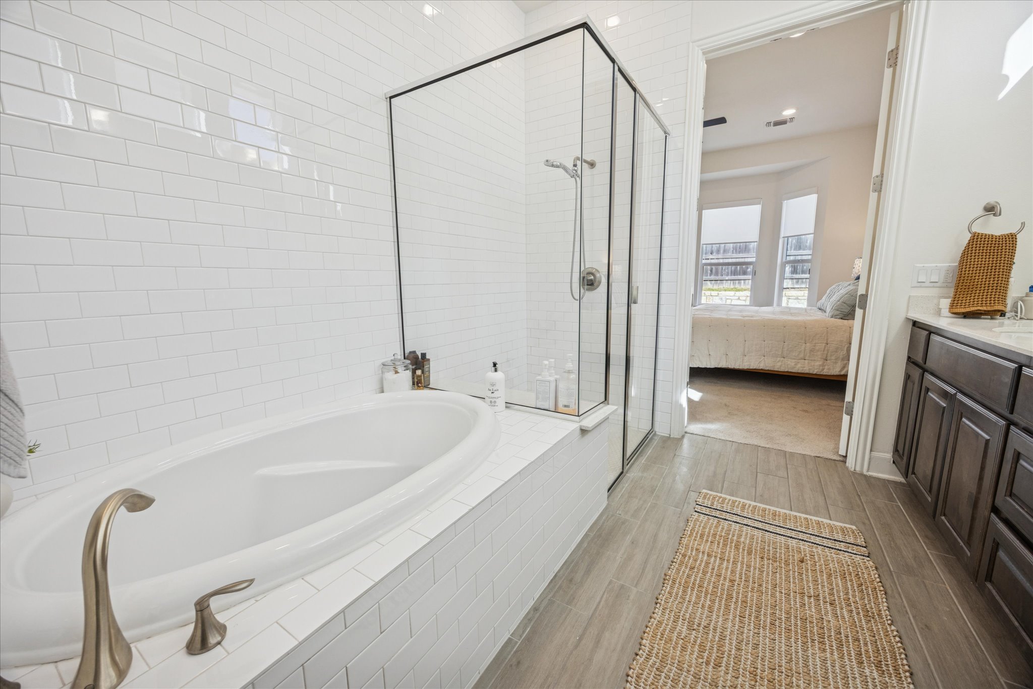 12507 Ayrshire Way, Unit 75 Austin, TX 78732 - Photo 17 of 40 Bathroom with a shower stall, vanity, a bath, and connected bathroom
