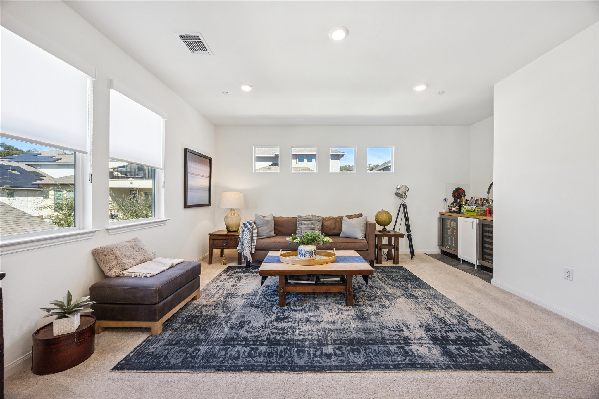 12507 Ayrshire Way, Unit 75 Austin, TX 78732 - Photo 19 of 40 Living area with light carpet, a bar, recessed lighting, and wine cooler