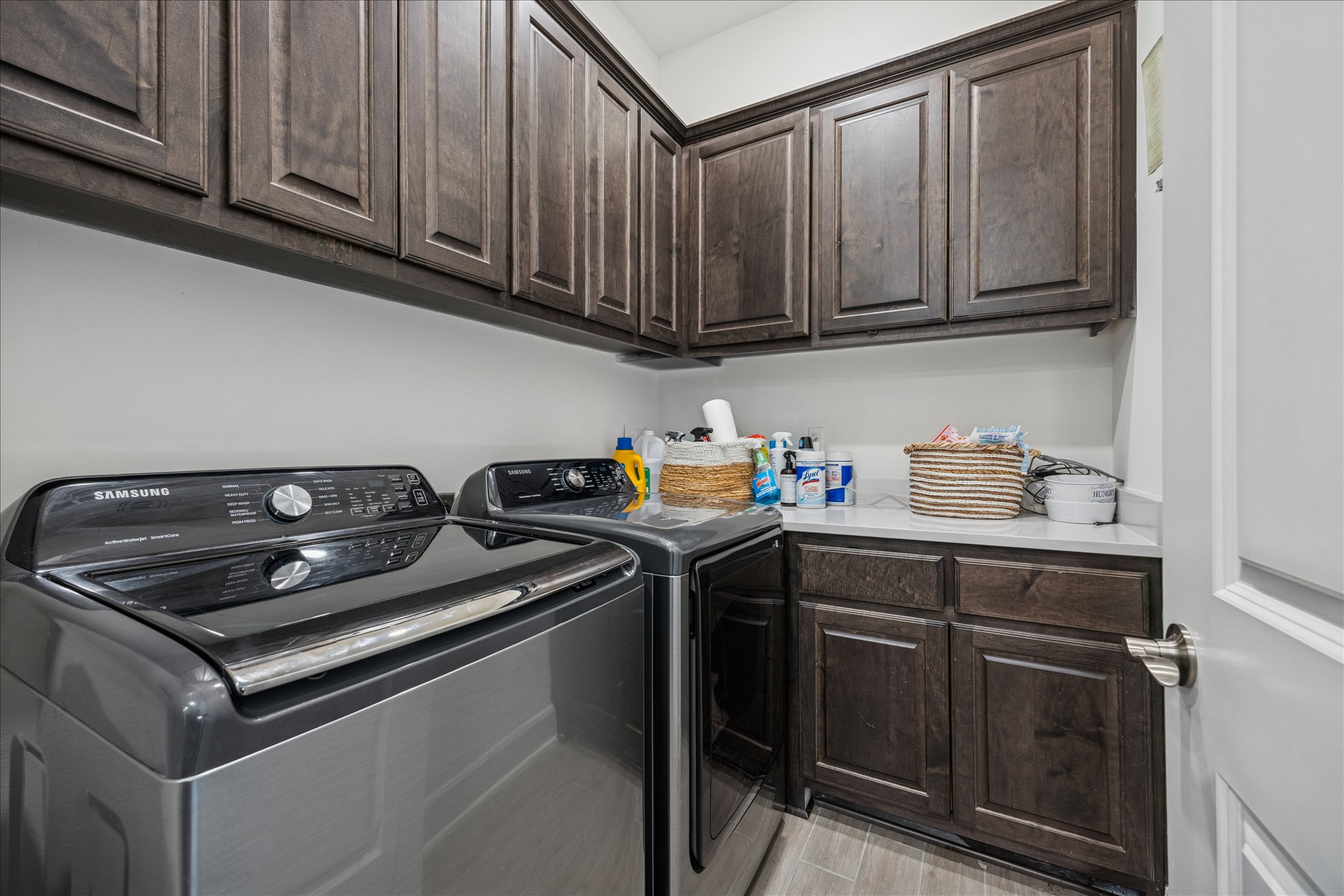 12507 Ayrshire Way, Unit 75 Austin, TX 78732 - Photo 27 of 40 Laundry room featuring washer and dryer, cabinet space, and light wood finished floors