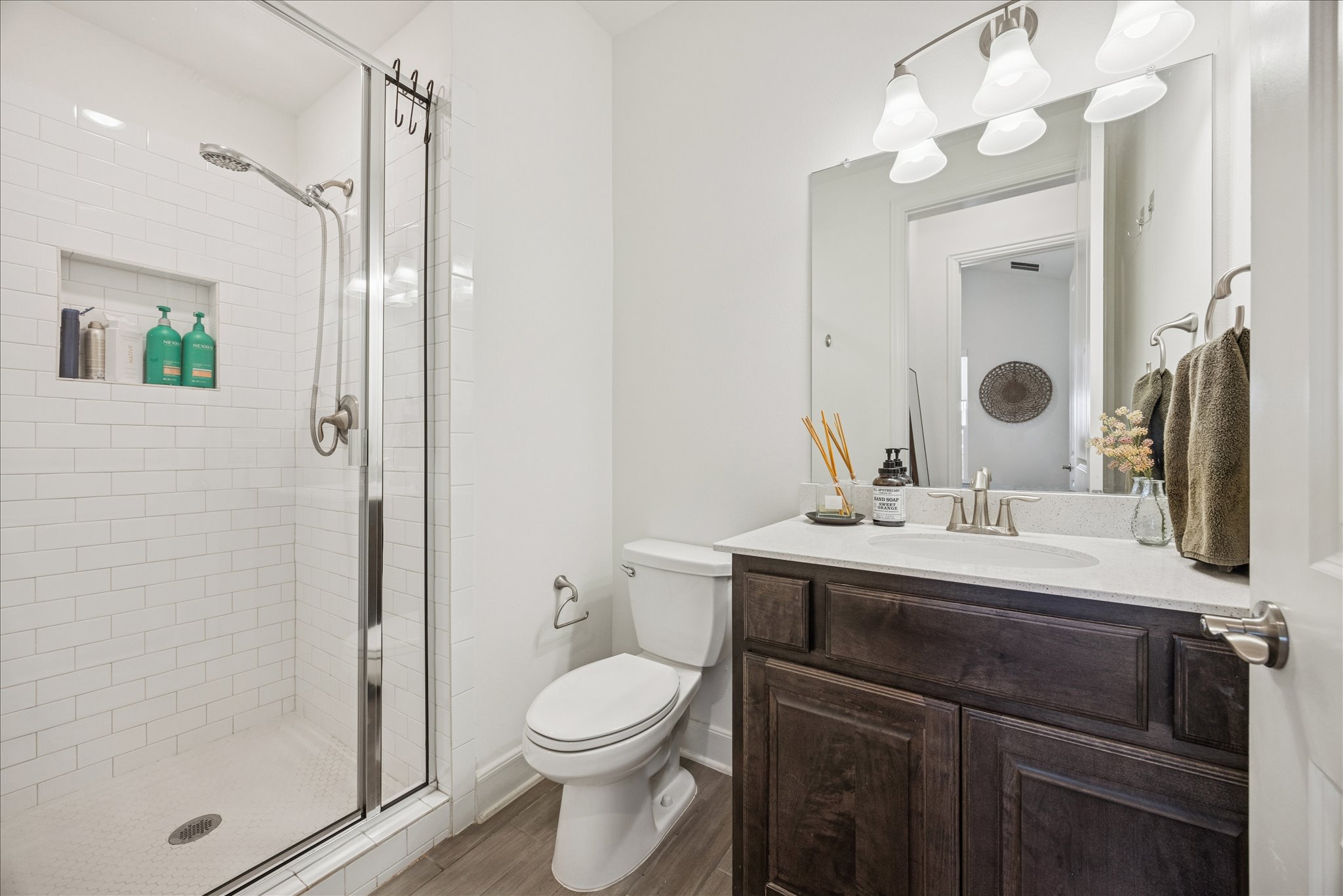 12507 Ayrshire Way, Unit 75 Austin, TX 78732 - Photo 29 of 40 Full bath with vanity, a stall shower, and light wood-type flooring