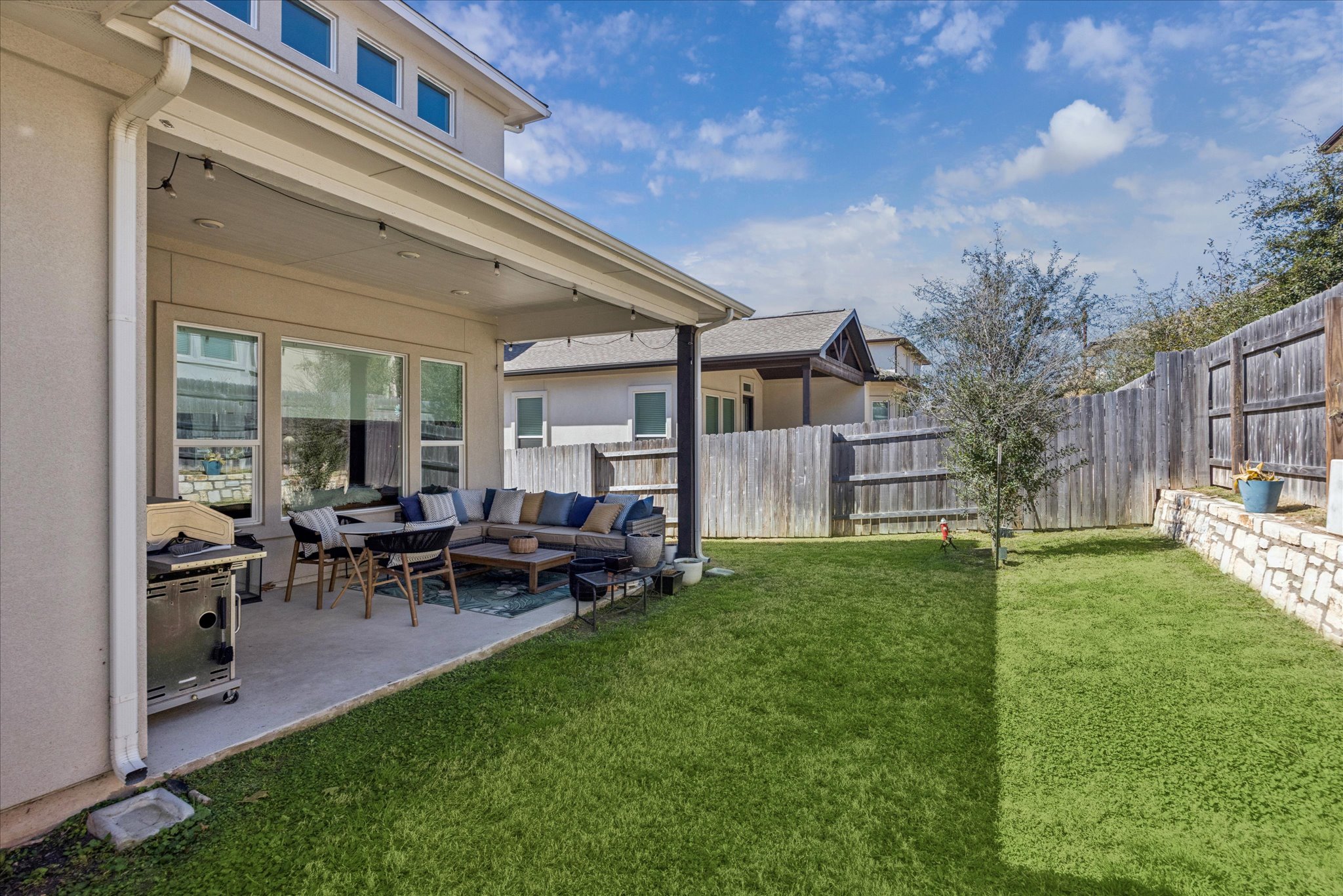 12507 Ayrshire Way, Unit 75 Austin, TX 78732 - Photo 32 of 40 Fenced backyard with an outdoor hangout area and a patio area