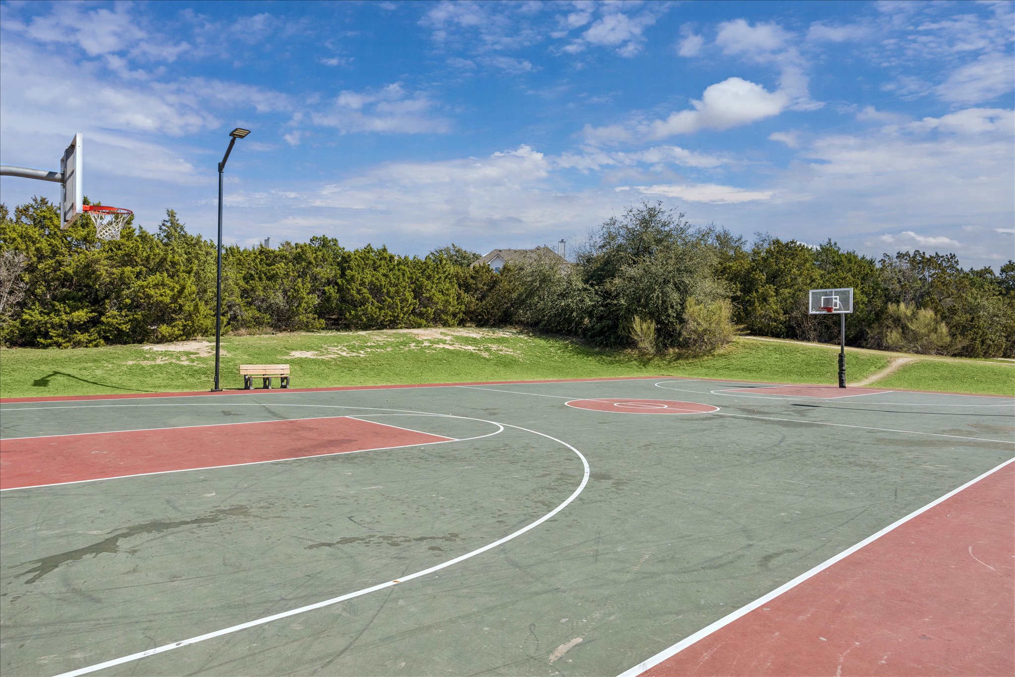 12507 Ayrshire Way, Unit 75 Austin, TX 78732 - Photo 37 of 40 View of sport court with community basketball court and a lawn