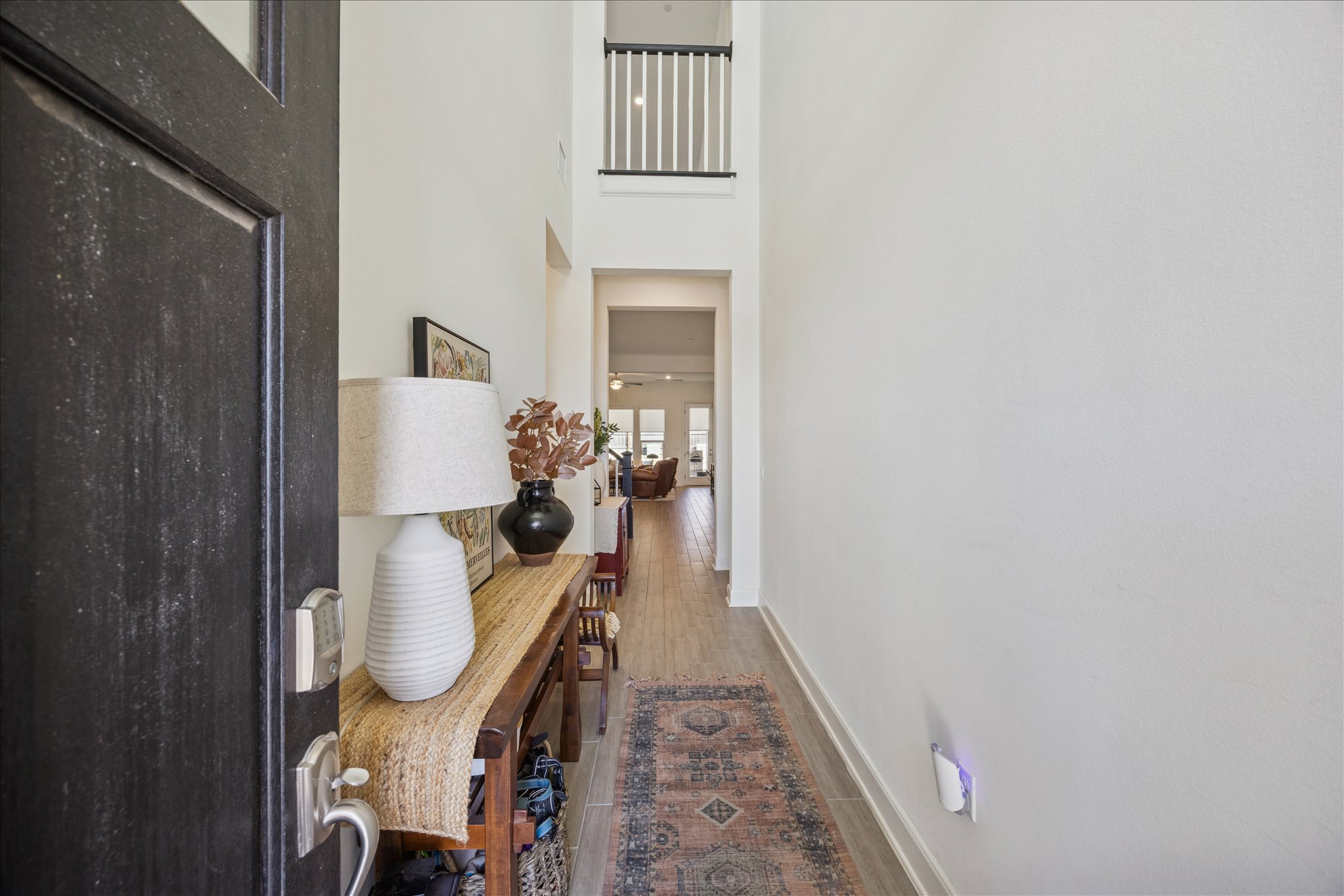 12507 Ayrshire Way, Unit 75 Austin, TX 78732 - Photo 4 of 40 Hallway with a high ceiling and dark wood finished floors