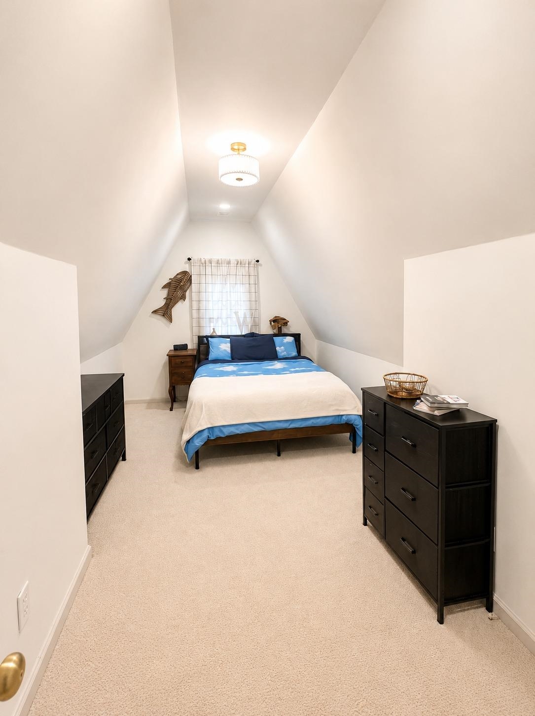 470 Rich Road Somerville, TN 38068 - Photo 40 of 40 Attic room featuring a vaulted ceiling with a central flush-mount light fixture and light-toned carpeting