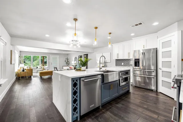 a kitchen with a stove and a chandelier