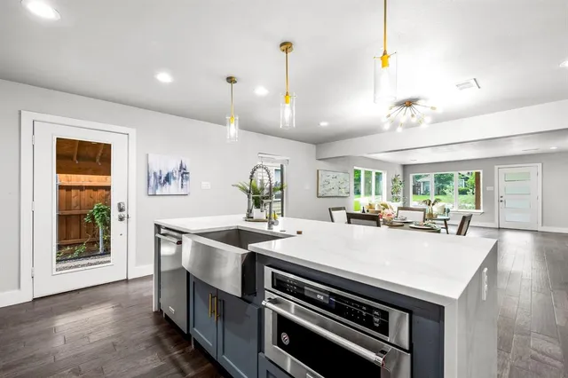 a kitchen with stainless steel appliances white cabinets and a stove