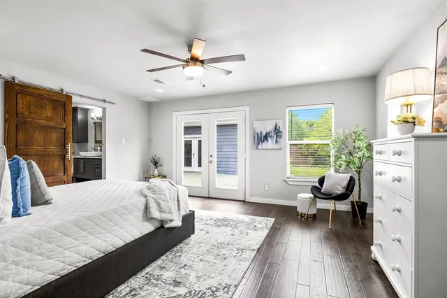 a bedroom with a large bed and a chandelier