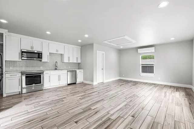 a kitchen with a refrigerator sink and cabinets