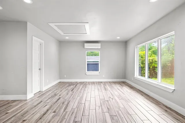 a big room with wooden floor and windows