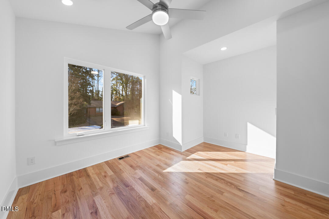 2530 West Wilson Street Durham, NC 27705 - Photo 30 of 49 a view of an empty room with wooden floor and a window