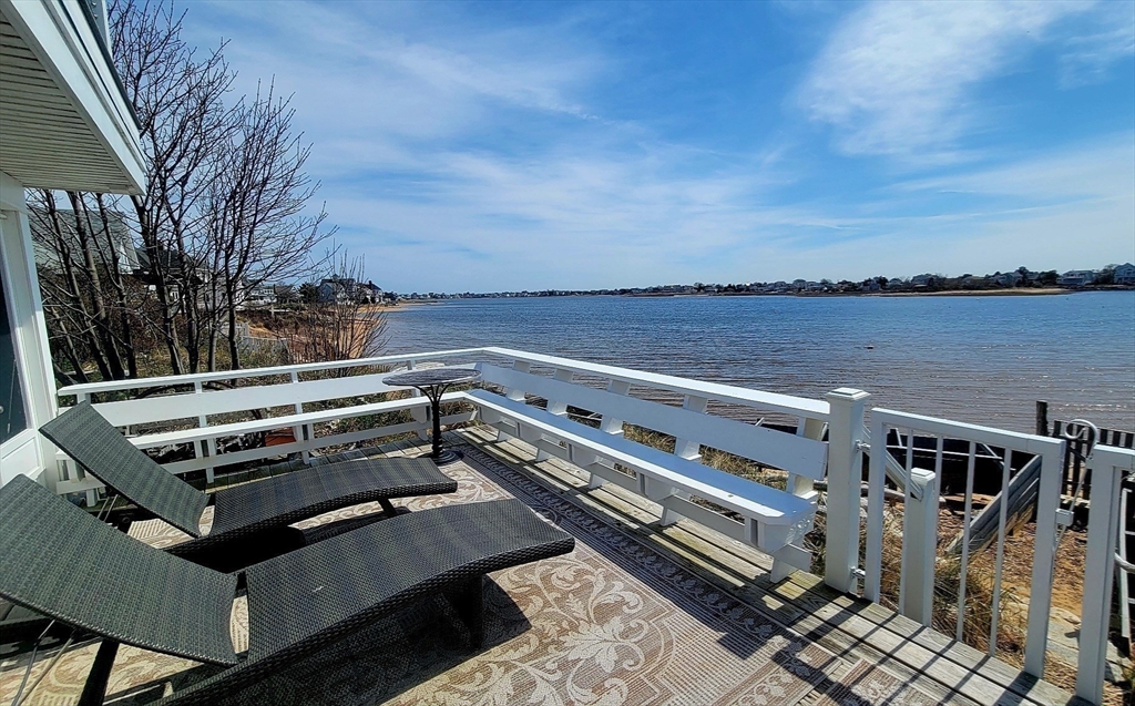 11 Harbor Street Newburyport, MA 01950 - Photo 27 of 39 a view of a roof deck with couches and wooden floor