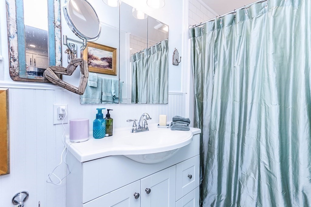 11 Harbor Street Newburyport, MA 01950 - Photo 29 of 39 a bathroom with a sink vanity and a mirror