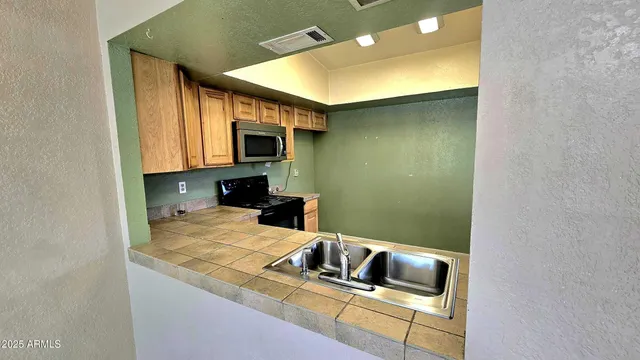 a kitchen with a sink stove and microwave