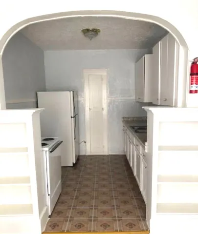 a kitchen with a refrigerator and a stove