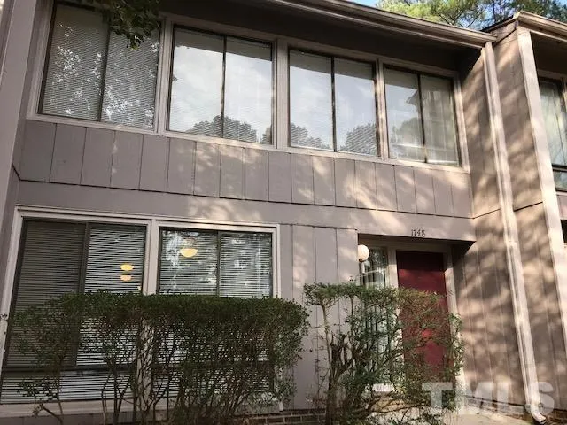 a front view of a house with large windows