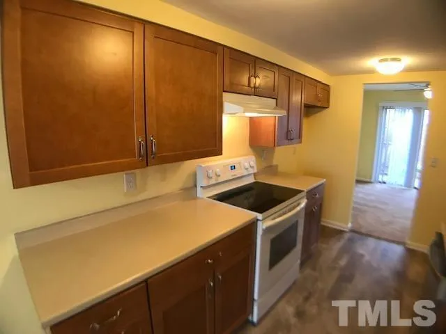 a kitchen with a stove and a refrigerator