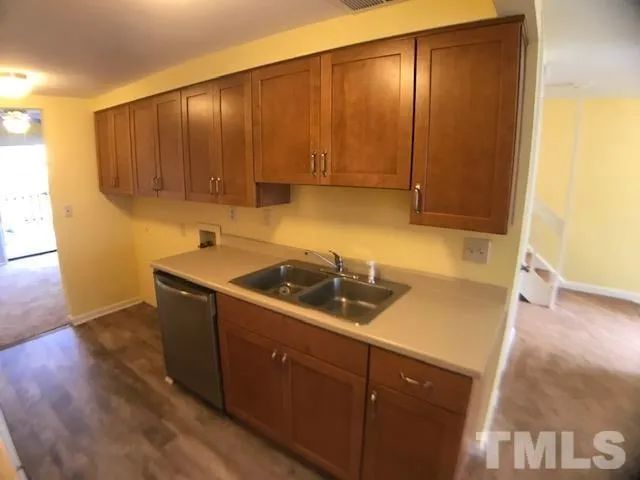a kitchen with a sink a stove and cabinets