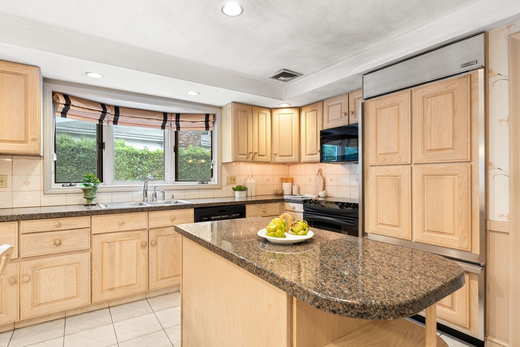 50 Tomahawk Road Arlington, MA 02474 - Photo 17 of 41 a kitchen with a sink a stove and white cabinets with wooden floor