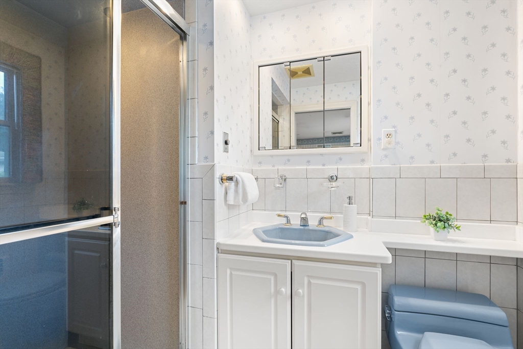 50 Tomahawk Road Arlington, MA 02474 - Photo 23 of 41 a bathroom with a sink and a mirror