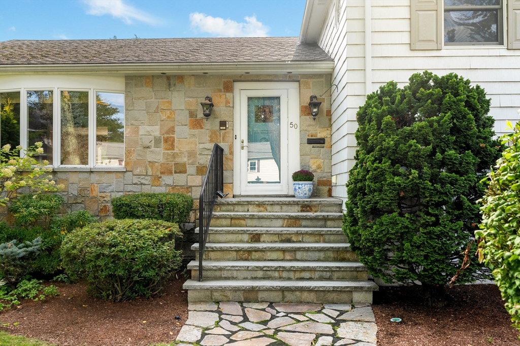 50 Tomahawk Road Arlington, MA 02474 - Photo 3 of 41 a front view of a house with plants and garden