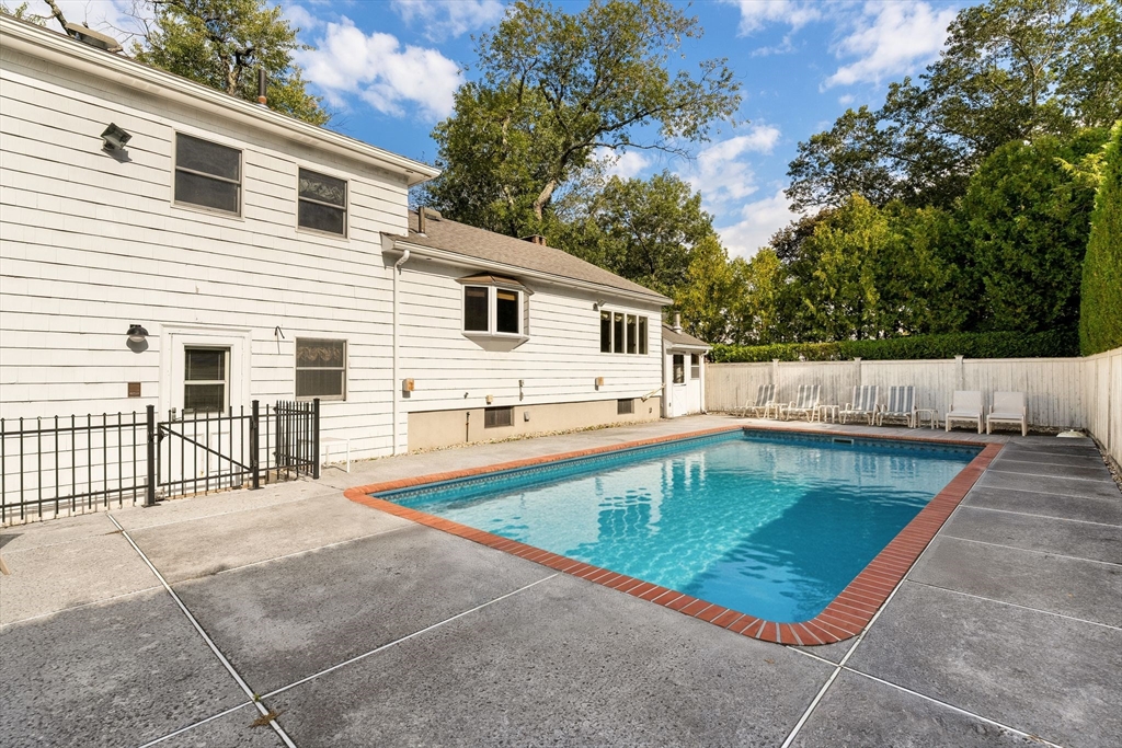 50 Tomahawk Road Arlington, MA 02474 - Photo 37 of 41 a view of a house with pool and a chairs