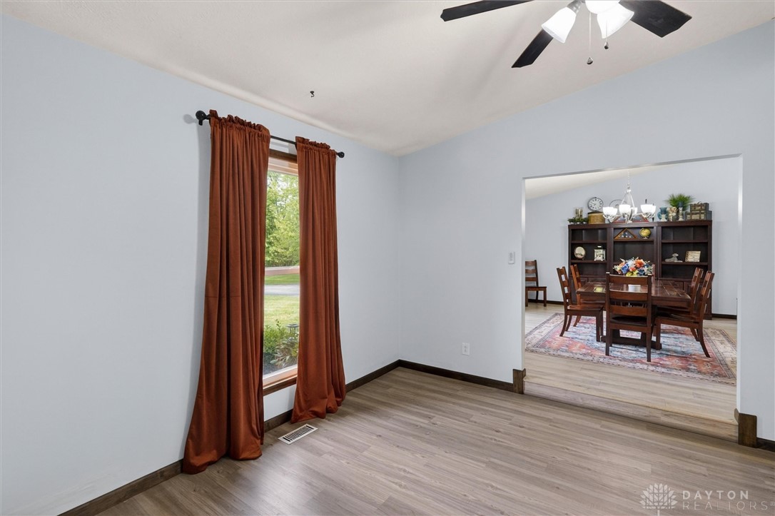 2165 Stewart Road Xenia, OH 45385 - Photo 4 of 59 This living room provides a welcoming atmosphere, featuring abundant natural light and an elegant ceiling fan.