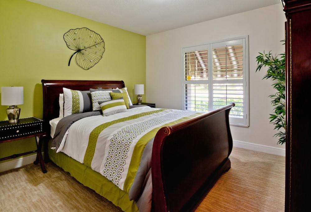 18090 104th Terrace South Boca Raton, FL 33498 - Photo 17 of 25 a bed sitting in a bedroom next to a window with potted plants