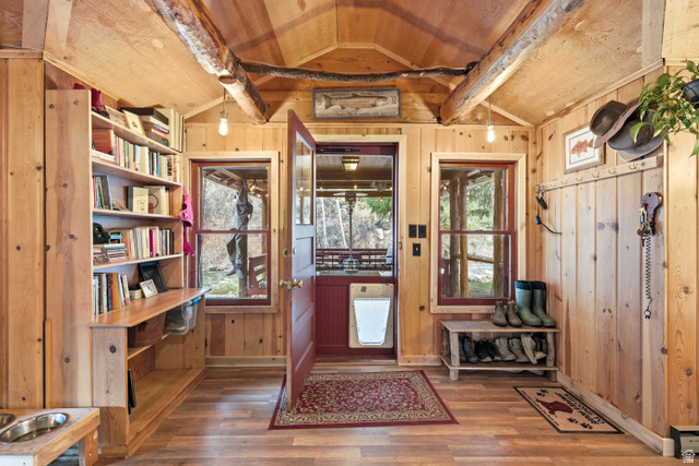 6631 Pine Springs Road Kamas, UT 84036 - Photo 11 of 48 Entryway featuring dark wood-type flooring, plenty of natural light, wooden walls, and wooden ceiling