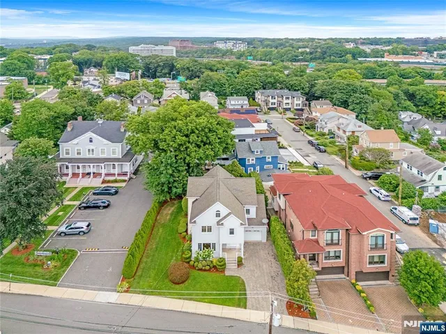 an aerial view of residential houses with outdoor space and street view