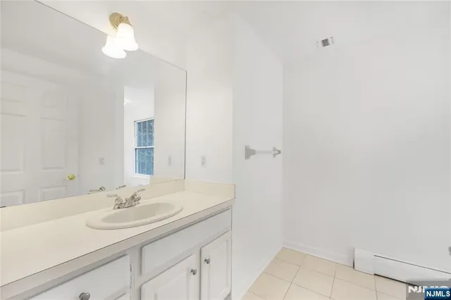 a bathroom with a sink a light fixture and a light fixture