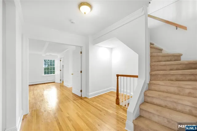 a view of an entryway with wooden floor and door