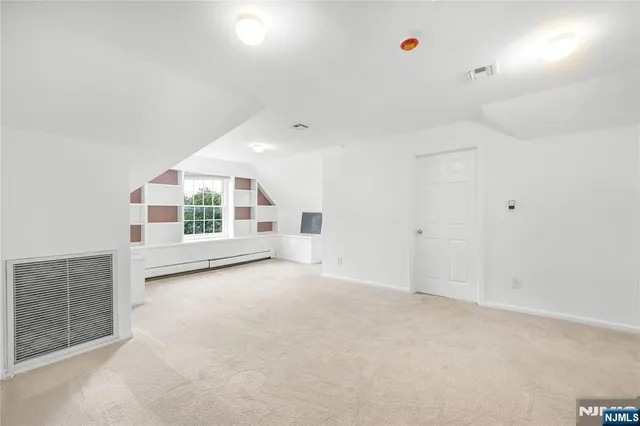 an empty room with windows and pillars in it