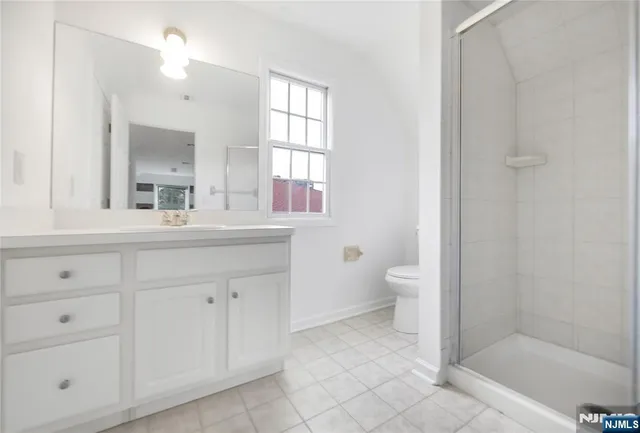 a bathroom with a double vanity sink a toilet and a mirror