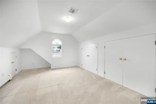 an empty room with a empty space and windows