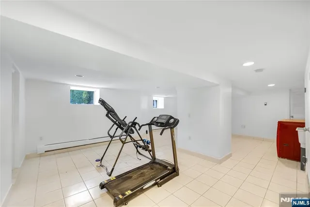 a room with gym equipment and white walls