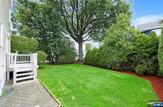 a view of a house with a backyard
