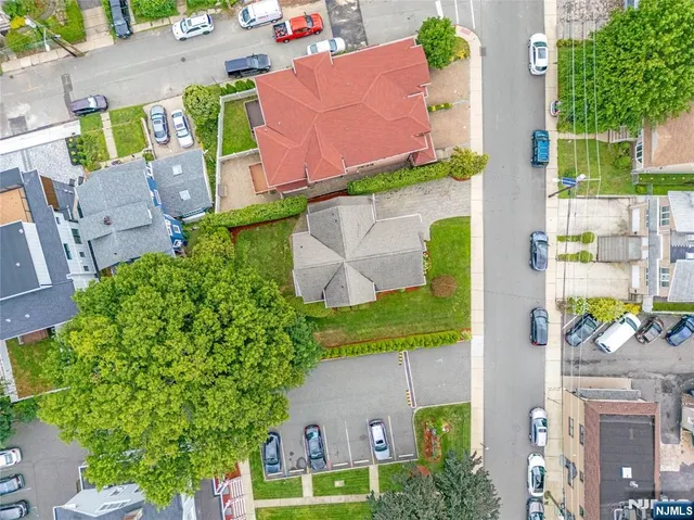 an aerial view of residential houses with outdoor space and street view