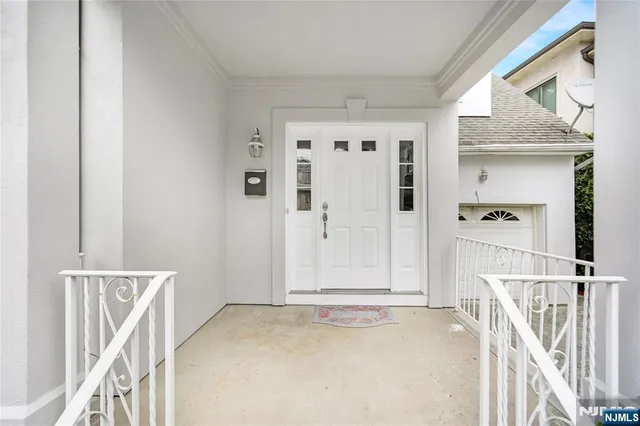 a view of a livingroom with wooden floor and white walls