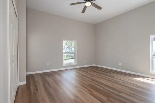 wooden floor in an empty room with a window