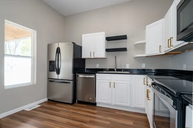 a kitchen with stainless steel appliances a refrigerator stove and sink