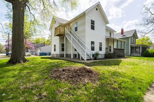 a front view of a house with a yard table and chairs