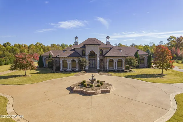a view of a house with pool and a yard