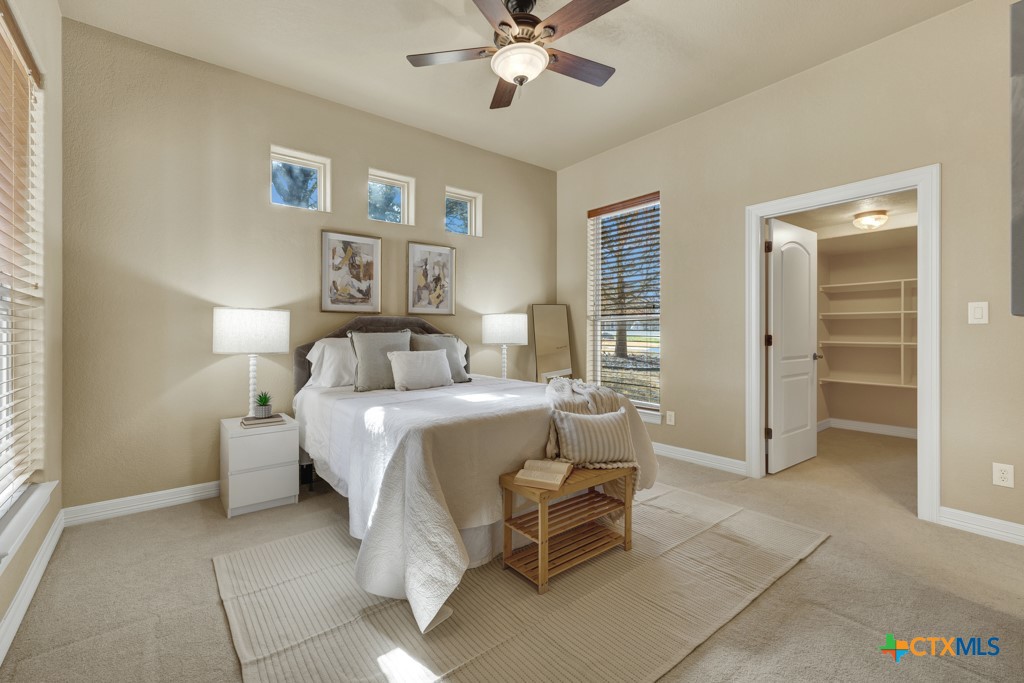 7607 Sky Loop Garden Ridge, TX 78266 - Photo 24 of 43 a bed room with a bed and a chandelier